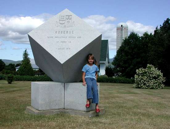 Faith Roberge sitting on the Roberge's monument on Ile d'Orleans
