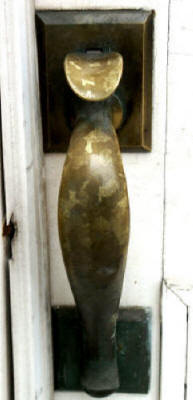 Brass door handle etched by repeated hand contact