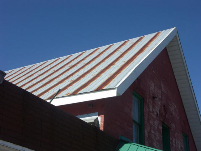 Rusting galvanized roof with regular bands of rust